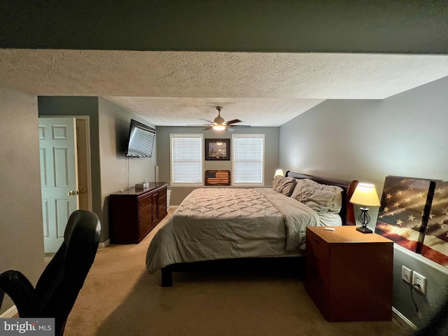 bedroom with light carpet, a textured ceiling, and ceiling fan