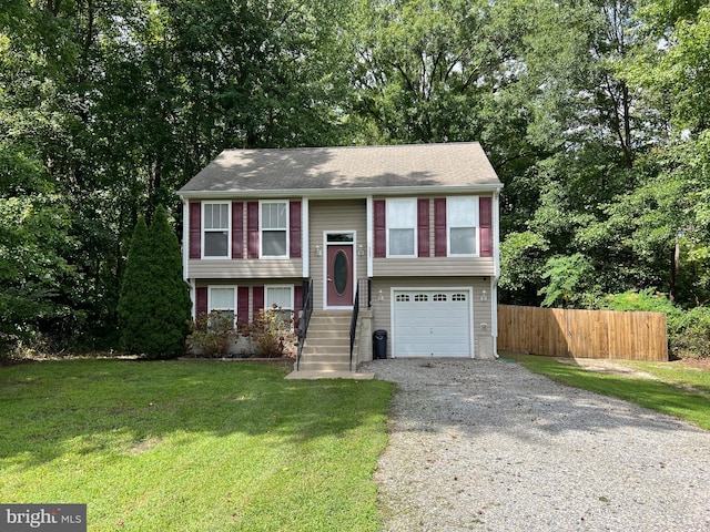 split foyer home featuring a front yard and a garage