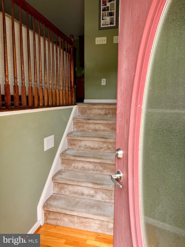 stairs with hardwood / wood-style floors