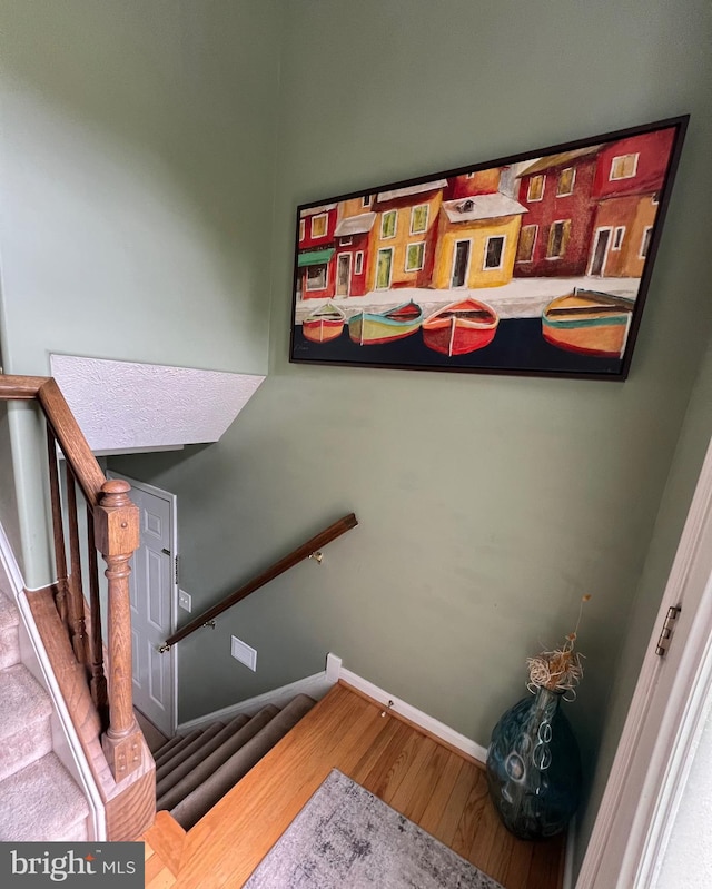 stairway with hardwood / wood-style flooring