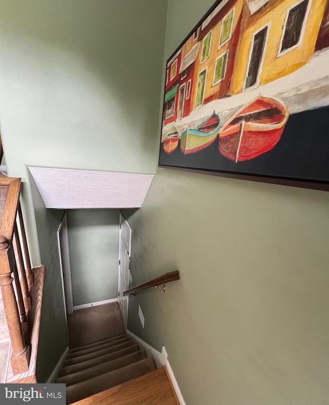 stairs featuring hardwood / wood-style flooring