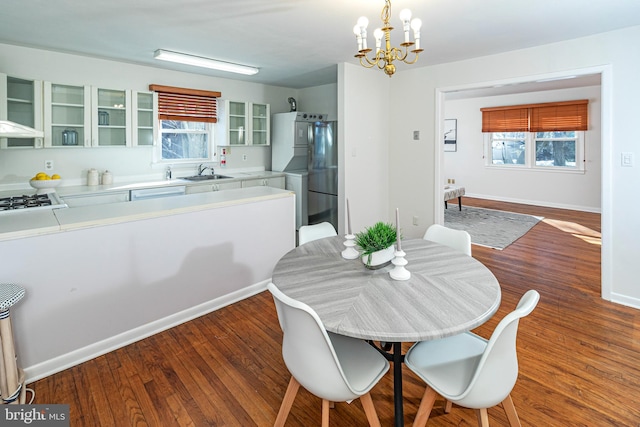 dining room featuring hardwood / wood-style flooring, plenty of natural light, and sink