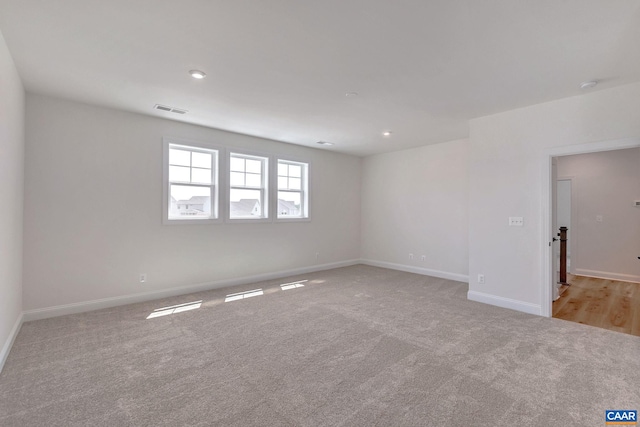 unfurnished room with light carpet