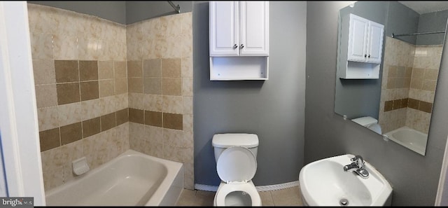 full bathroom with tile patterned floors, tiled shower / bath combo, toilet, and sink