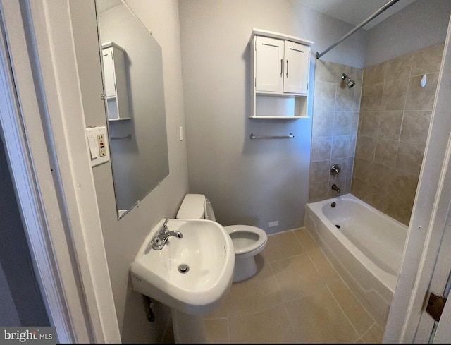 full bathroom with tile patterned floors, tiled shower / bath combo, toilet, and sink