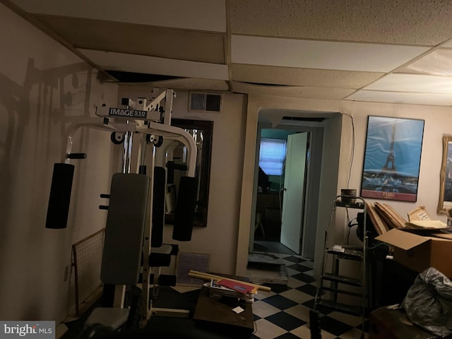 workout area with a paneled ceiling