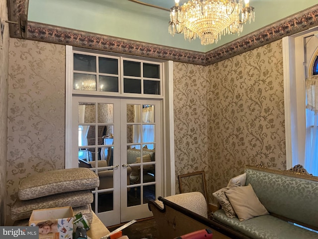 living area with french doors and a chandelier