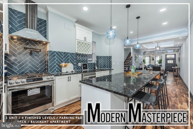 kitchen with white cabinets, stainless steel appliances, dark hardwood / wood-style floors, and ornamental molding