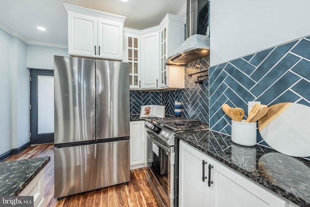 kitchen with white cabinetry, wall chimney range hood, black range with gas stovetop, dark hardwood / wood-style floors, and stainless steel fridge