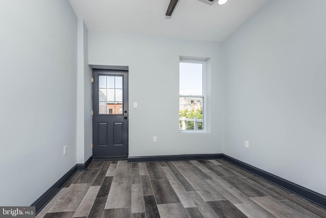 foyer entrance featuring ceiling fan and dark wood-type flooring