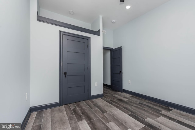 empty room with dark hardwood / wood-style floors