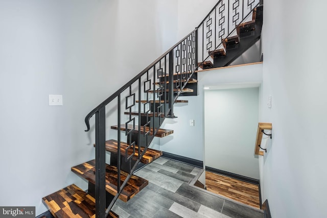 stairs featuring hardwood / wood-style flooring