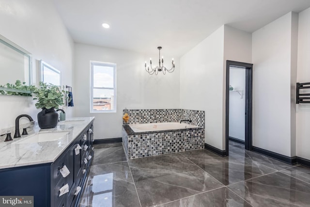 bathroom featuring a notable chandelier, a relaxing tiled tub, and vanity