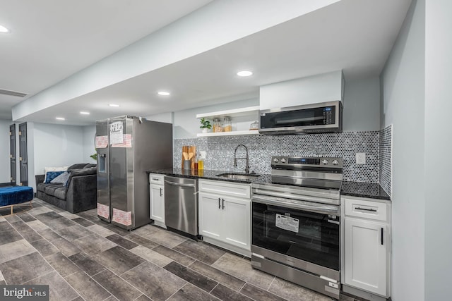 kitchen with sink, dark hardwood / wood-style floors, appliances with stainless steel finishes, tasteful backsplash, and white cabinetry