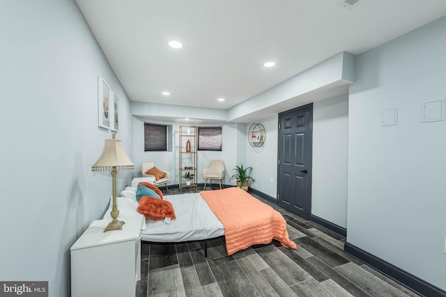 bedroom with dark hardwood / wood-style floors