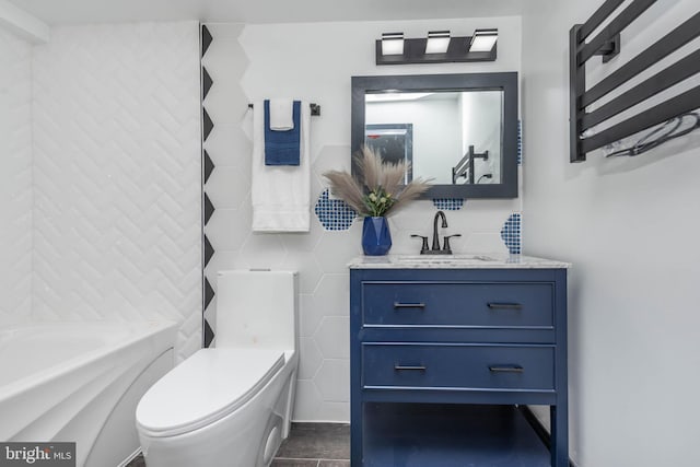 bathroom with tile patterned flooring, vanity, toilet, and tile walls