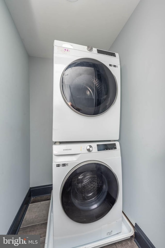 clothes washing area featuring stacked washer / dryer