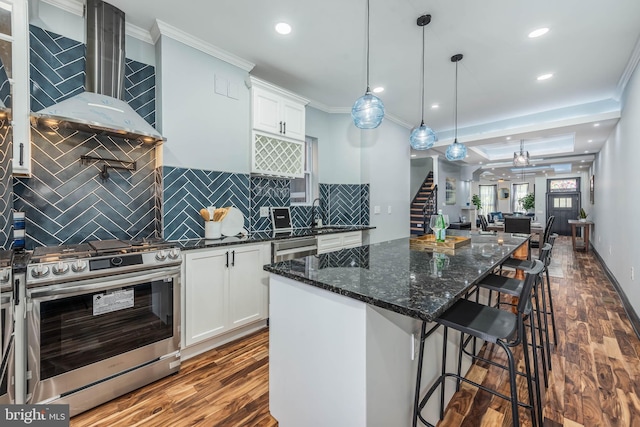 kitchen with white cabinets, dark hardwood / wood-style flooring, crown molding, and appliances with stainless steel finishes