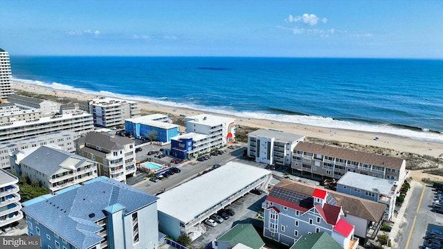 birds eye view of property with a view of the beach and a water view