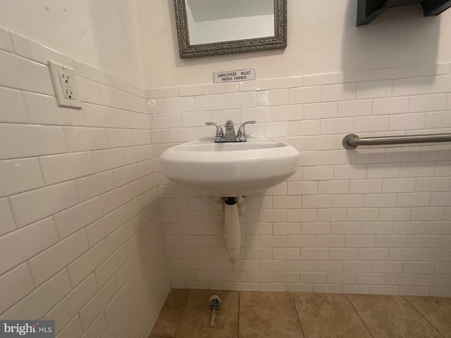 bathroom with tile patterned floors, tile walls, and sink