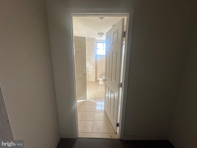 hallway featuring light tile patterned flooring