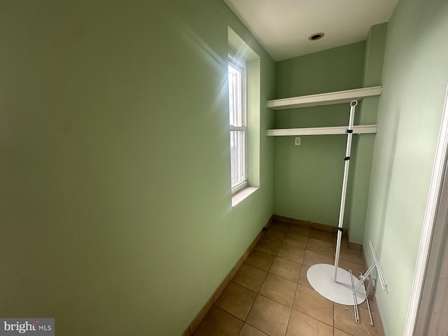 walk in closet featuring light tile patterned flooring