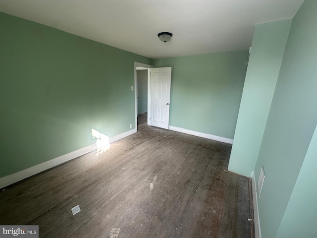 spare room featuring dark wood-type flooring