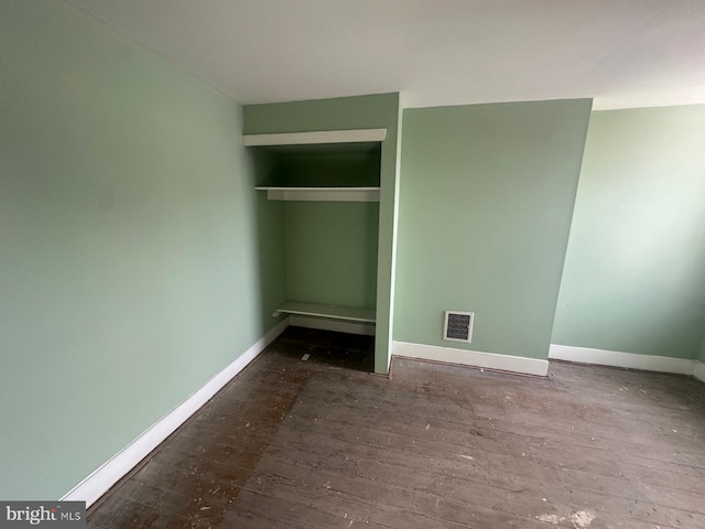 unfurnished bedroom with wood-type flooring and a closet