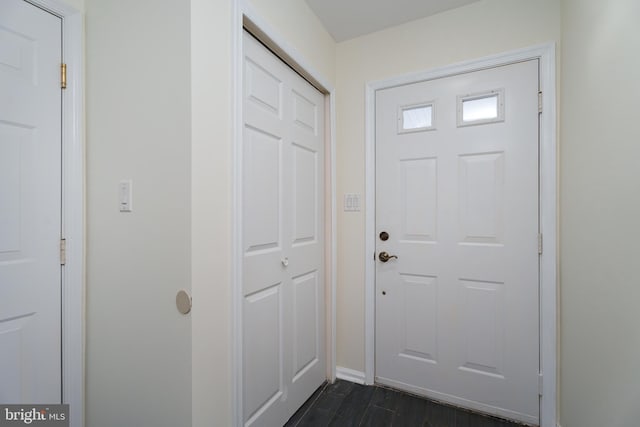 doorway with dark hardwood / wood-style floors