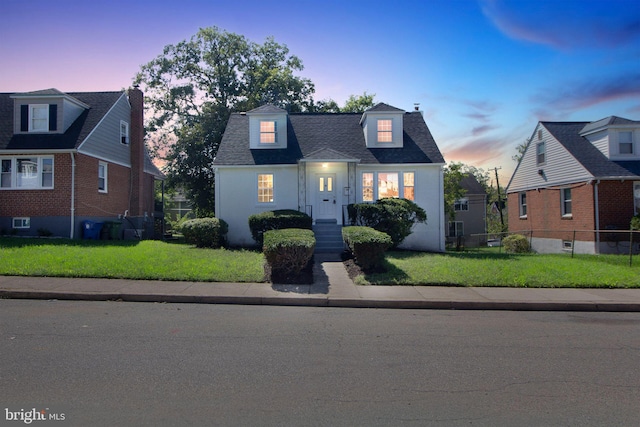 new england style home with a lawn