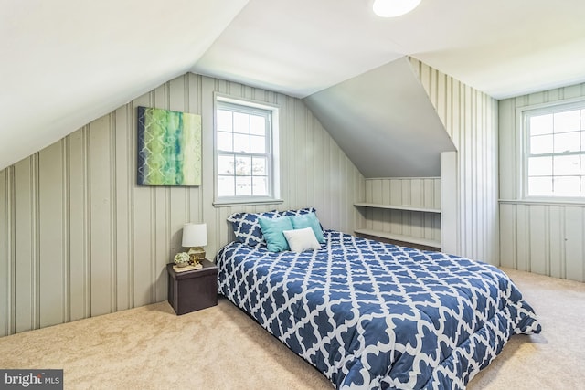 carpeted bedroom featuring lofted ceiling