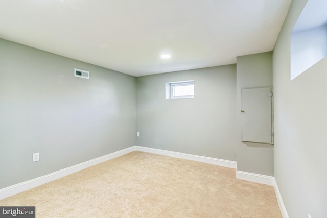 basement featuring light carpet