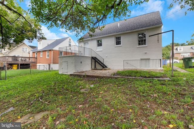 rear view of property featuring a yard