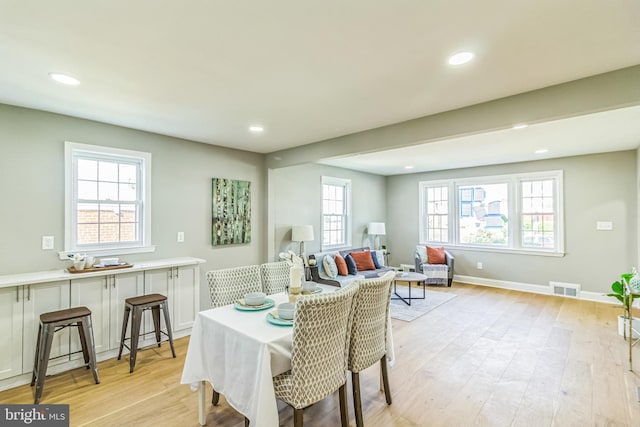 dining room featuring plenty of natural light and light hardwood / wood-style floors