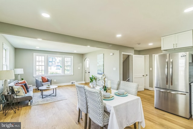 dining space with light hardwood / wood-style flooring