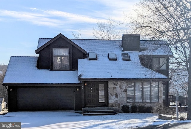 view of front of house with an attached garage and stone siding