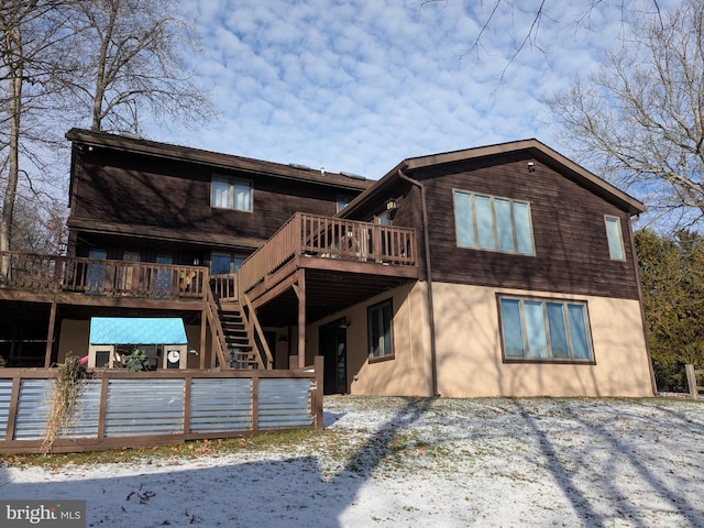 rear view of property featuring a wooden deck