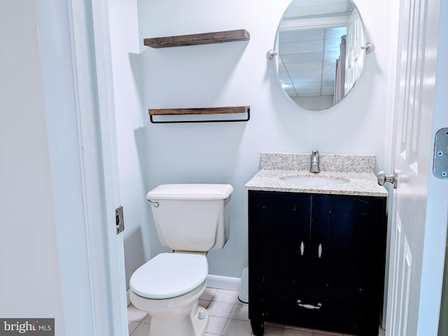 bathroom with tile patterned floors, baseboards, toilet, and vanity