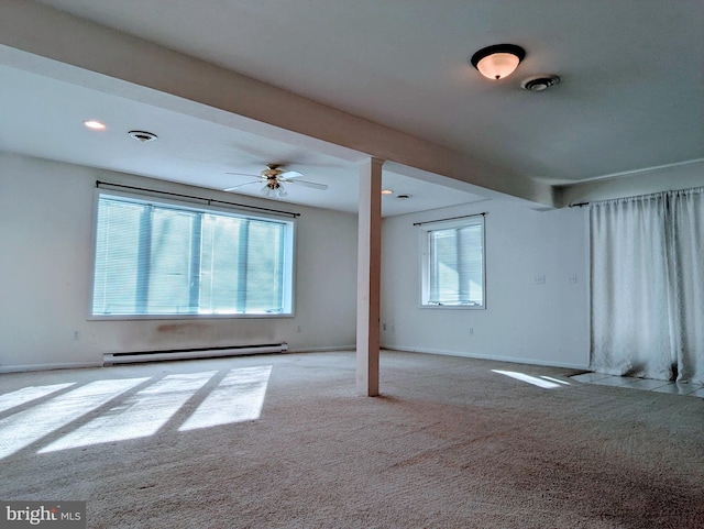 carpeted empty room with a baseboard heating unit, baseboards, visible vents, and ceiling fan