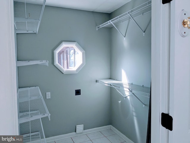 laundry room with light tile patterned floors and hookup for an electric dryer