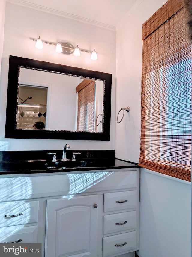 bathroom featuring vanity and ornamental molding