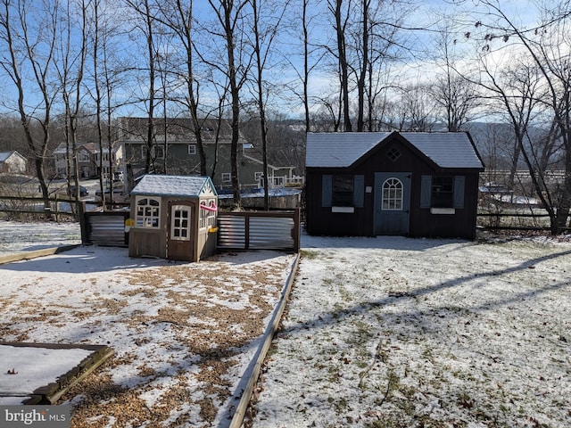 view of front facade featuring a residential view, a storage unit, and an outdoor structure