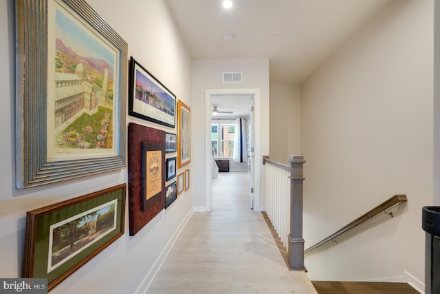 corridor with light hardwood / wood-style floors