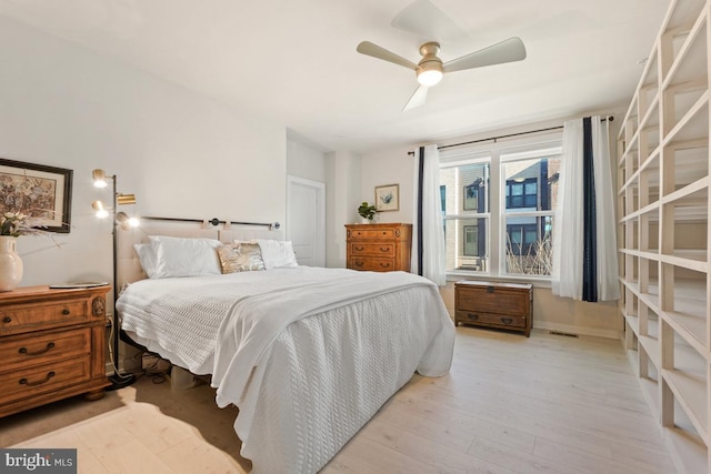 bedroom with ceiling fan and light hardwood / wood-style flooring