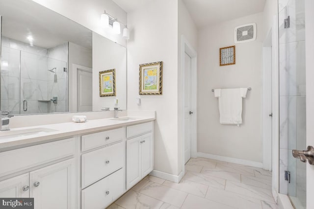 bathroom with a shower with door and vanity