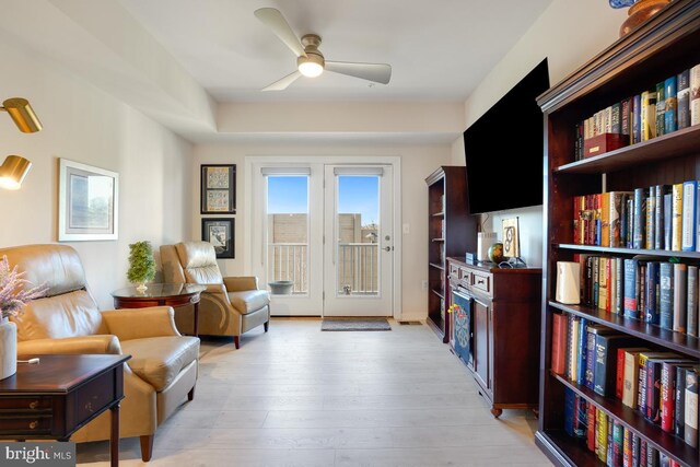 living area with ceiling fan and light hardwood / wood-style floors