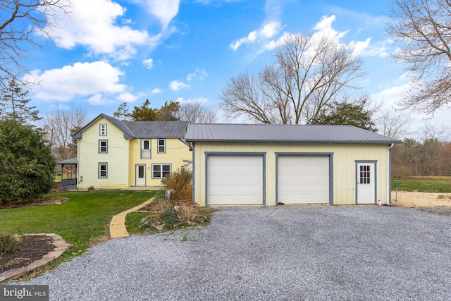 view of front of property with a garage and a front lawn