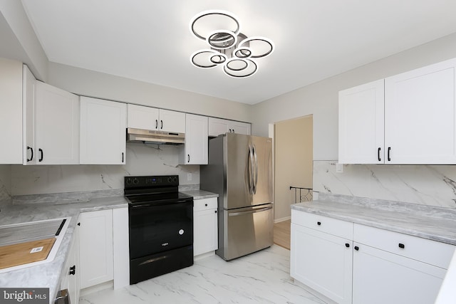 kitchen featuring black / electric stove, white cabinets, sink, tasteful backsplash, and stainless steel refrigerator