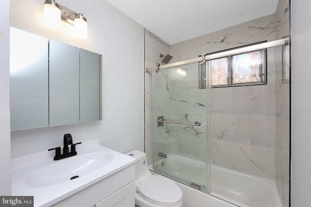 full bathroom with vanity, toilet, and bath / shower combo with glass door