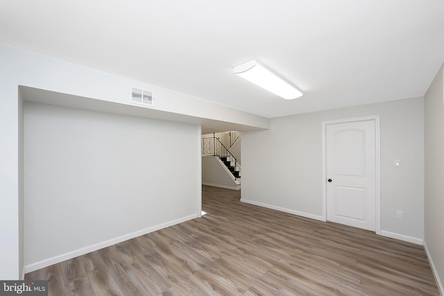 basement with hardwood / wood-style flooring